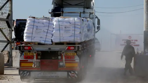 Reuters A lorry carrying humanitarian aid crosses into southern Gaza via the Israeli-controlled Kerem Shalom crossing in southern Israel (11 November 2024)