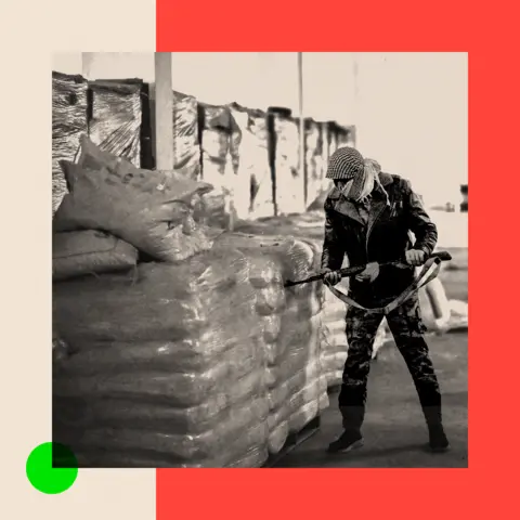 BBC Treated black and white image showing Syrian rebel fighters inspect sacks