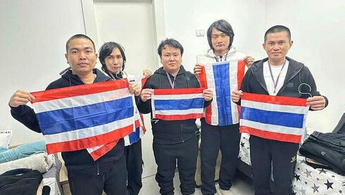 Freed Thai hostages pose triumphantly with national flag at Israeli hospital