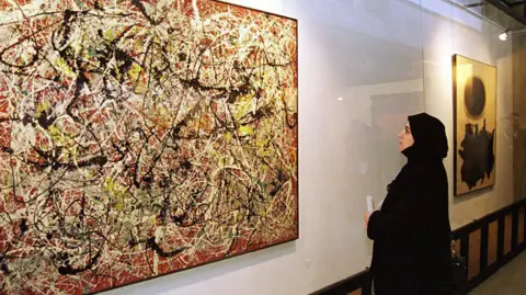 Kaveh Kazemi/Getty Images A female visitor views a painting by American abstract expressionist painter Jackson Pollock at the Tehran Museum of Contemporary Art in 1999