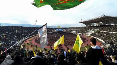 Reuters Crowds wave flags in a stadium