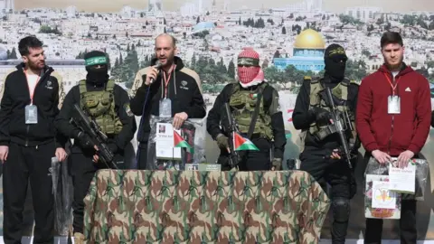 Reuters Sagui Dekel-Chen (left), Yair Horn (speaking, centre) and Sasha Troufanov (right) during their release by Hamas in Khan Younis, 15 February 