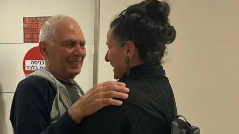 Efrat Machikawa Gadi Moses embraces his niece in an Israeli hospital