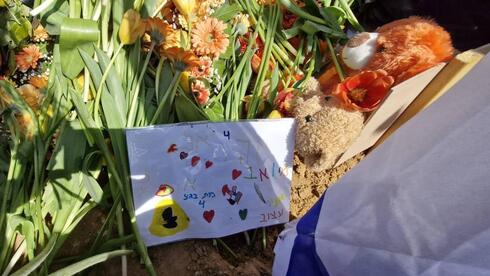 Teddy bears, and a drawing from a friend placed on Ariel Bibas’ gr