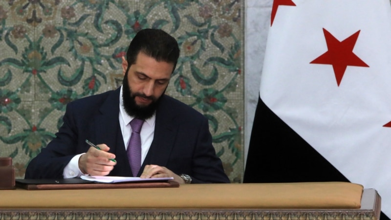 Syrian leader signs constitution putting Islamist group in charge for 5 years