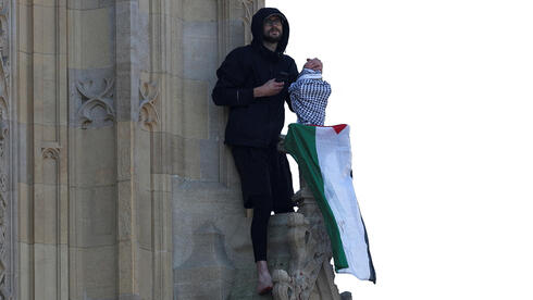 Friendly neighborhood protestor? Man scales Big Ben with a Palestinian flag