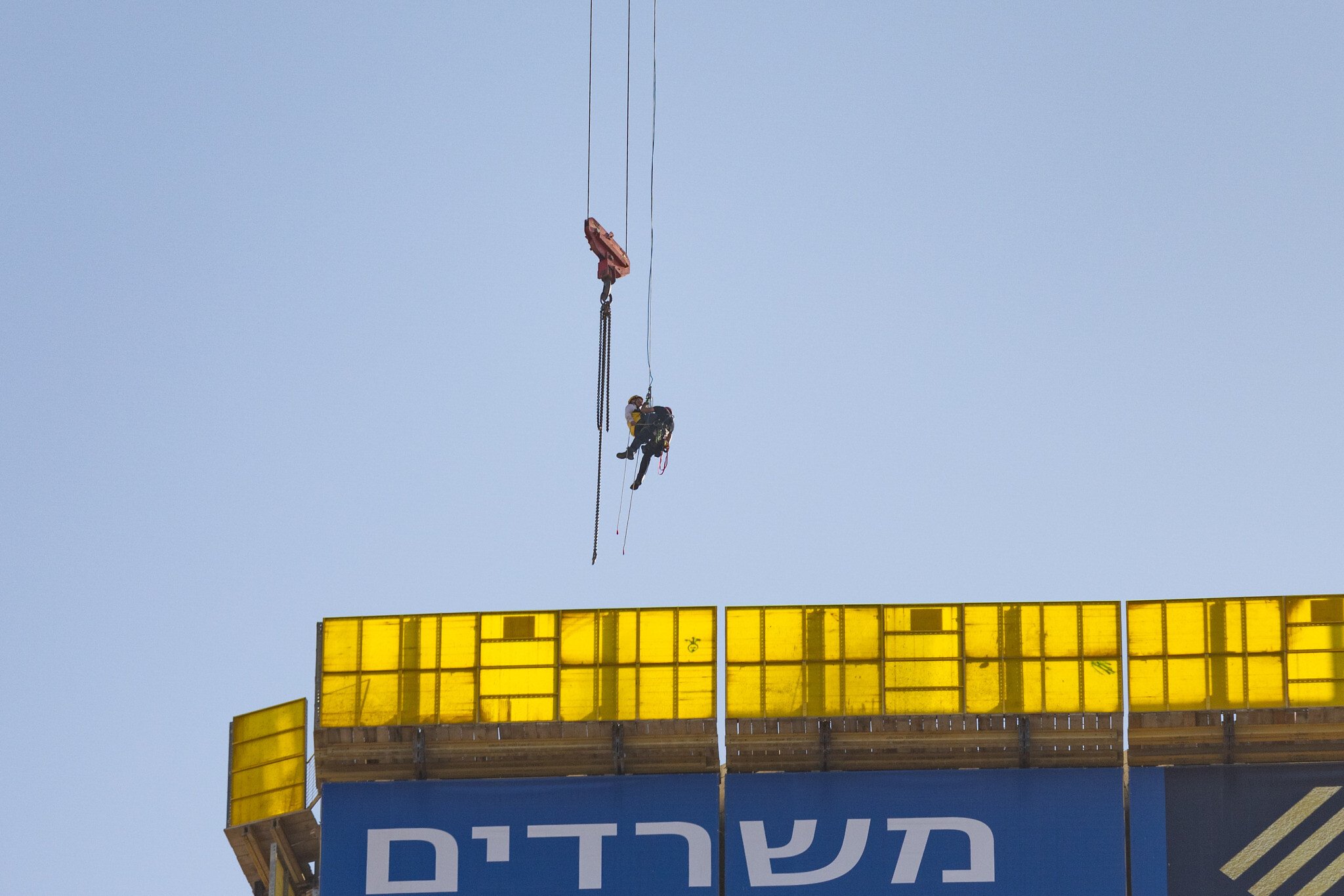 Firefighters rescue teenage boy hanging from crane in Jerusalem