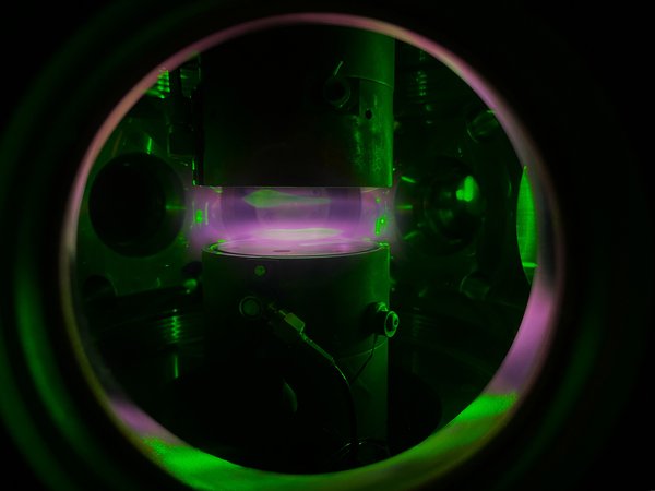 Icy Hot Plasmas: Fluffy, Electrically Charged Ice Grains Reveal New Plasma Dynamics