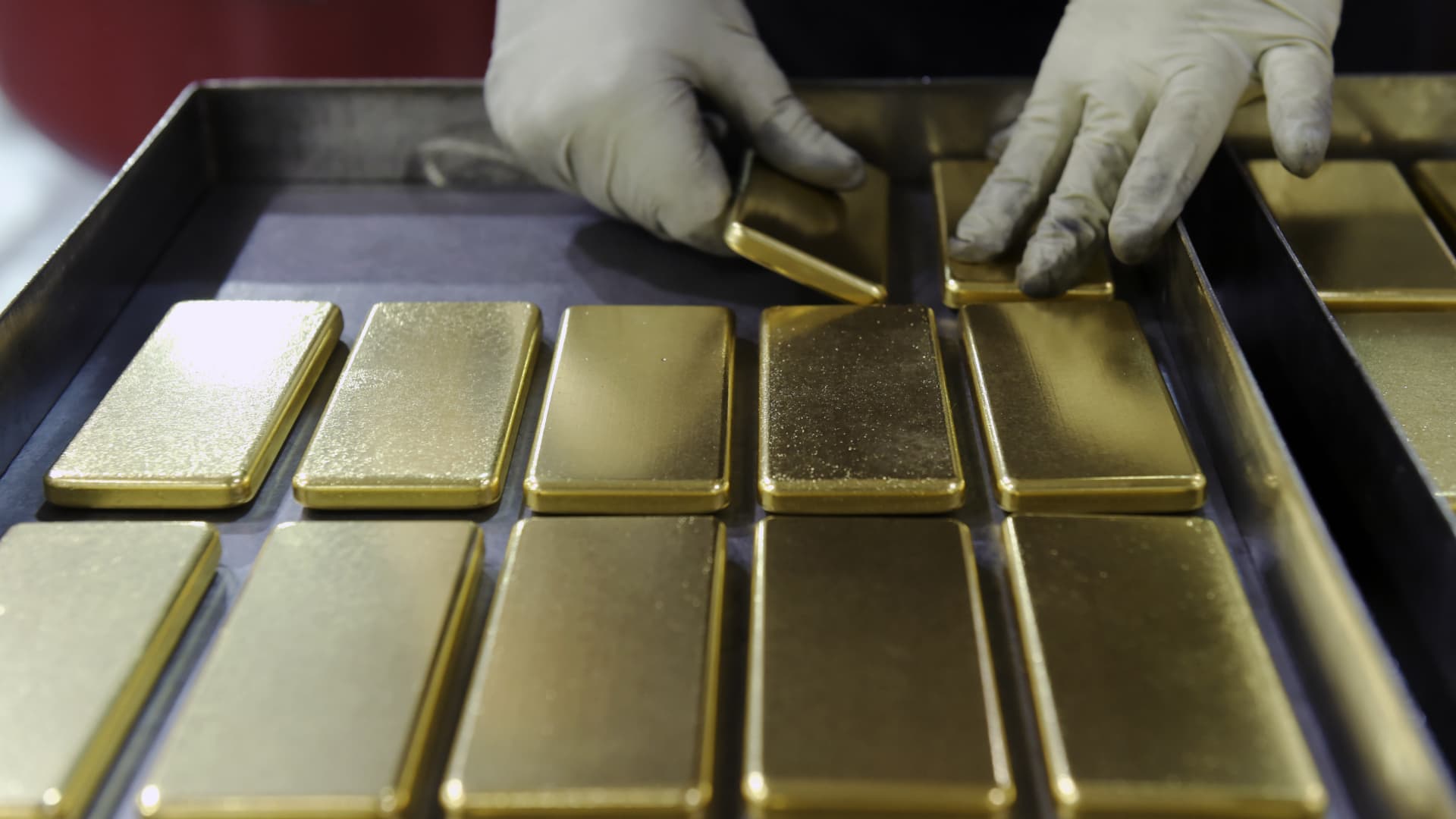 Gold prices fall on firmer dollar, dimming rate-cut hopes